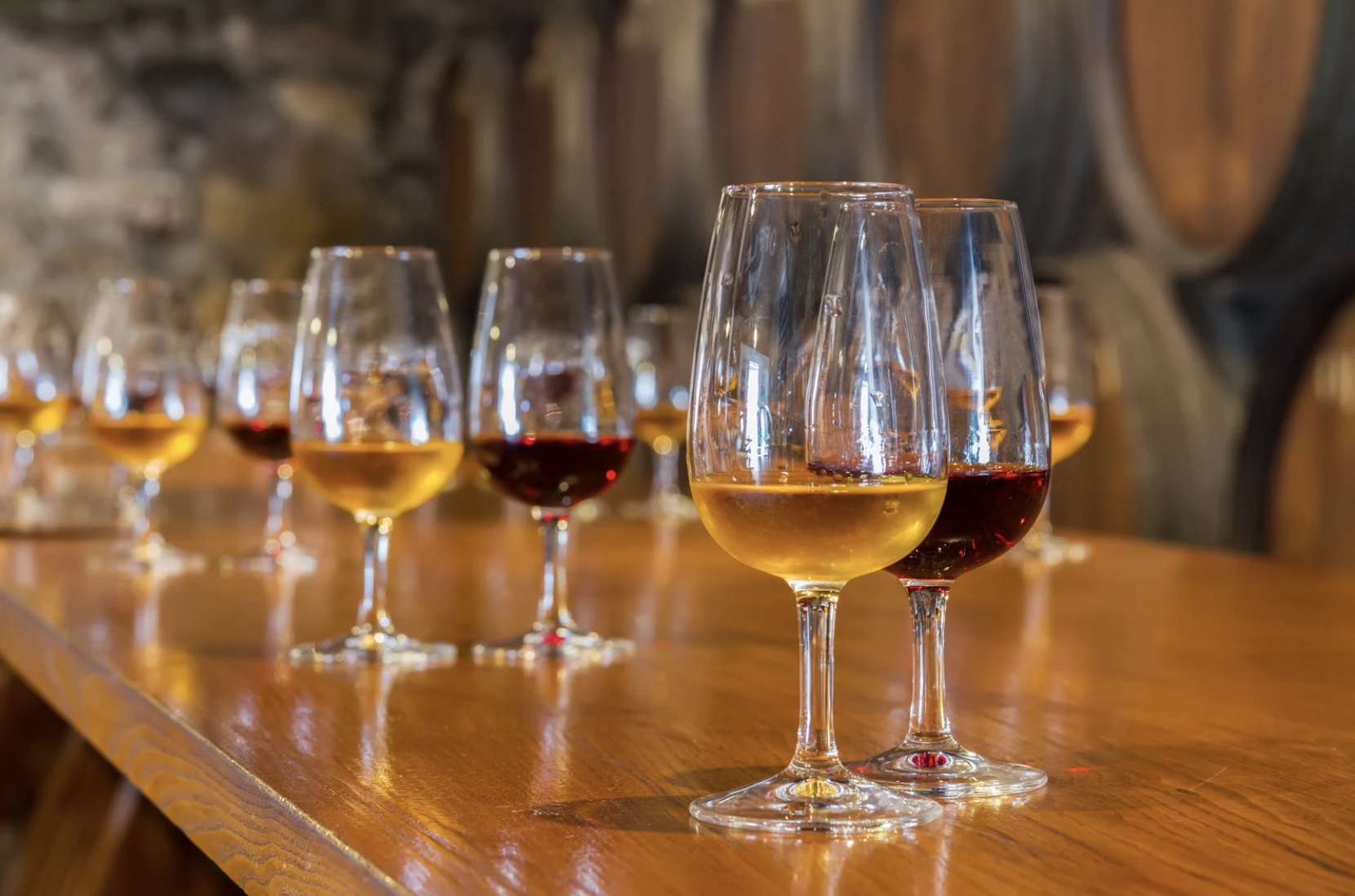 a glass of wine sitting on top of a wooden table