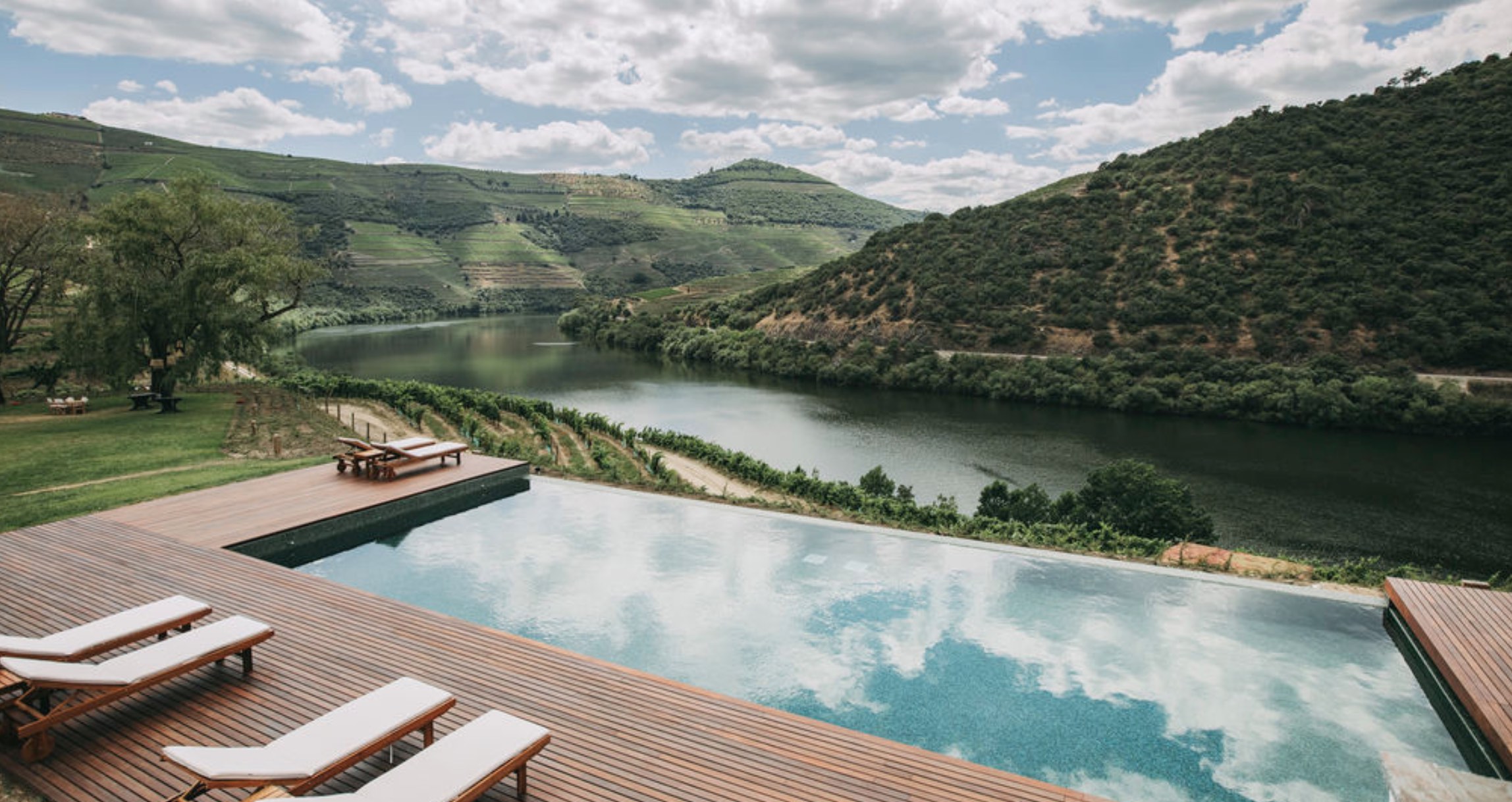 a wooden bench sitting next to a body of water