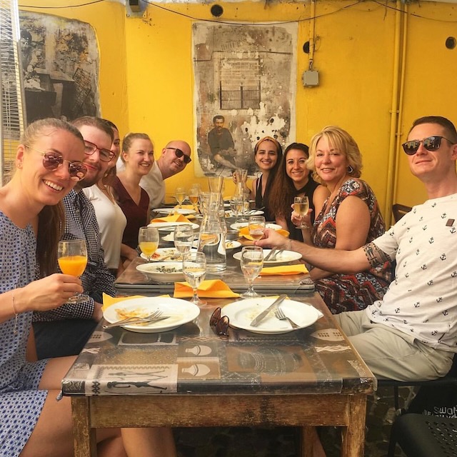 a group of people sitting at a table in a restaurant