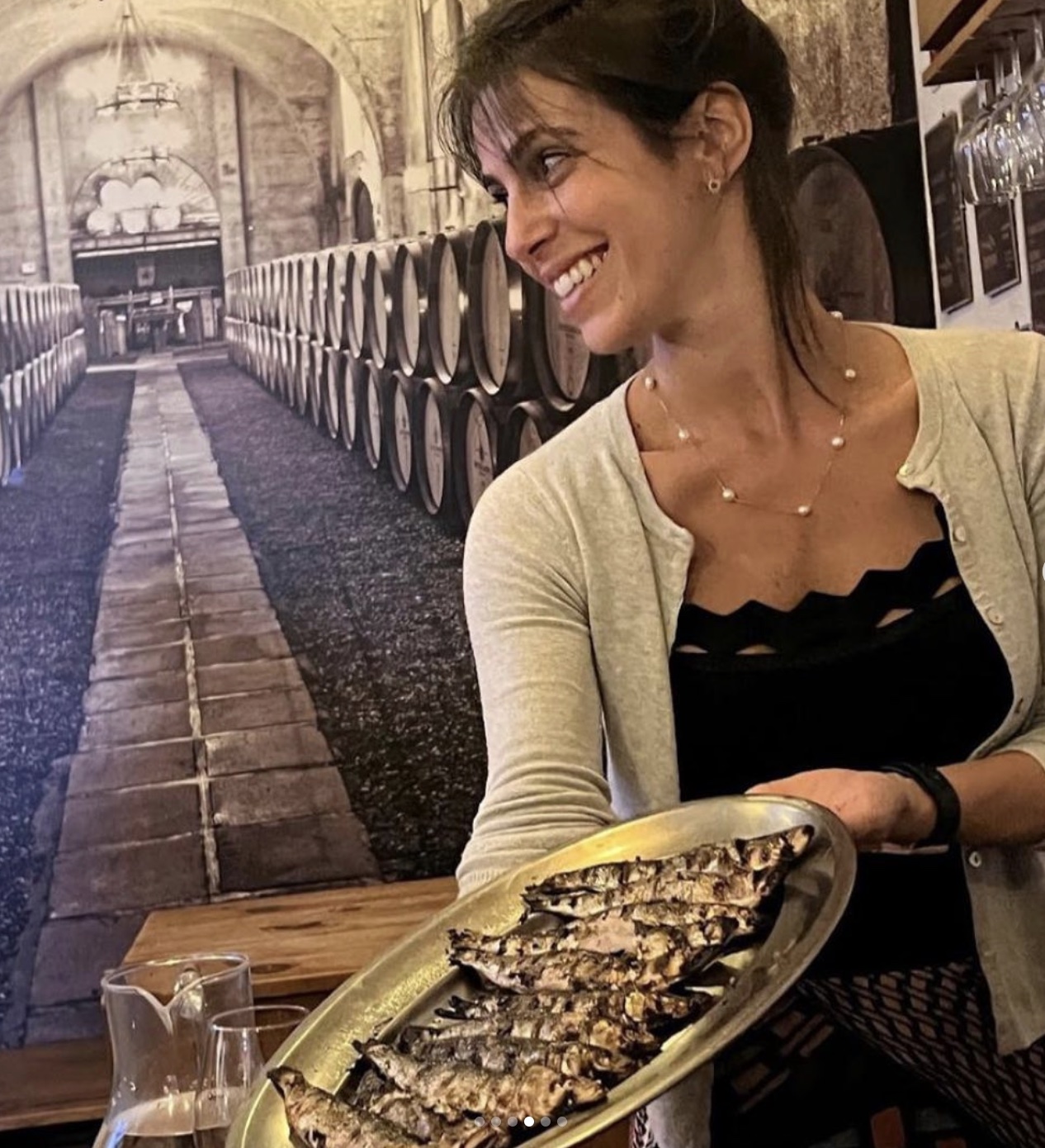 a woman sitting at a table with food