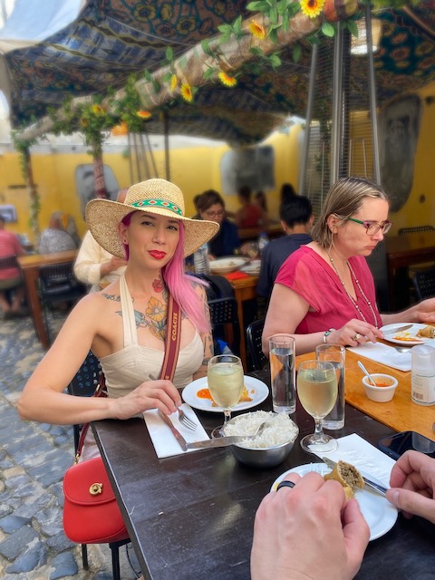 a group of people sitting at a table eating food