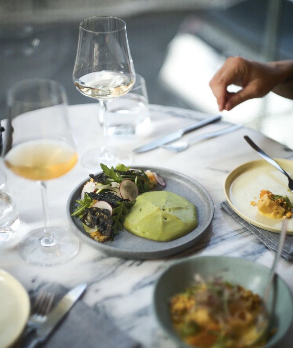 a group of people sitting at a table with a plate of food