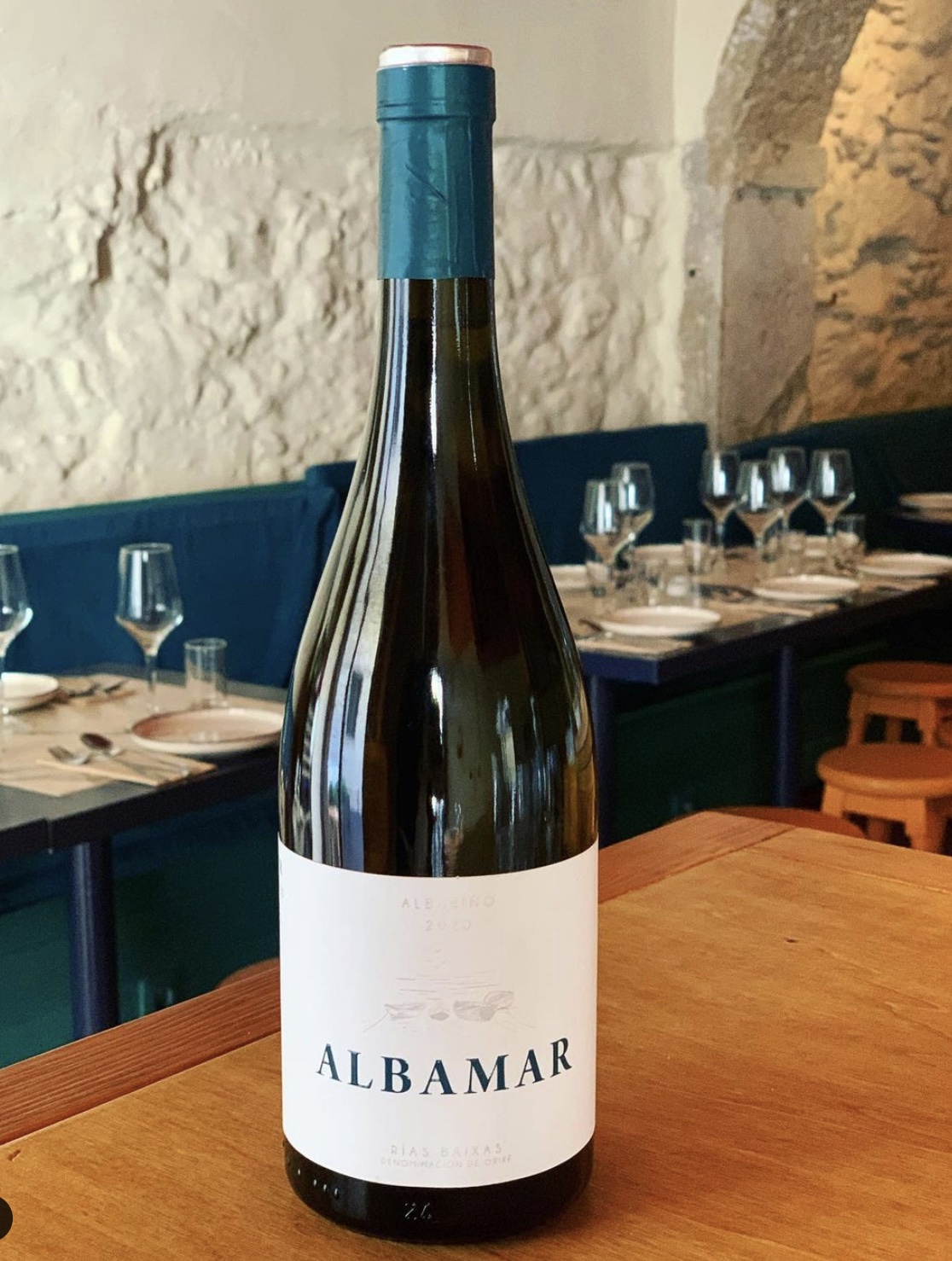 a bottle of wine sitting on top of a wooden table