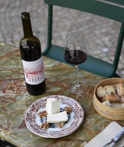 a plate of food and a bottle of wine on a table