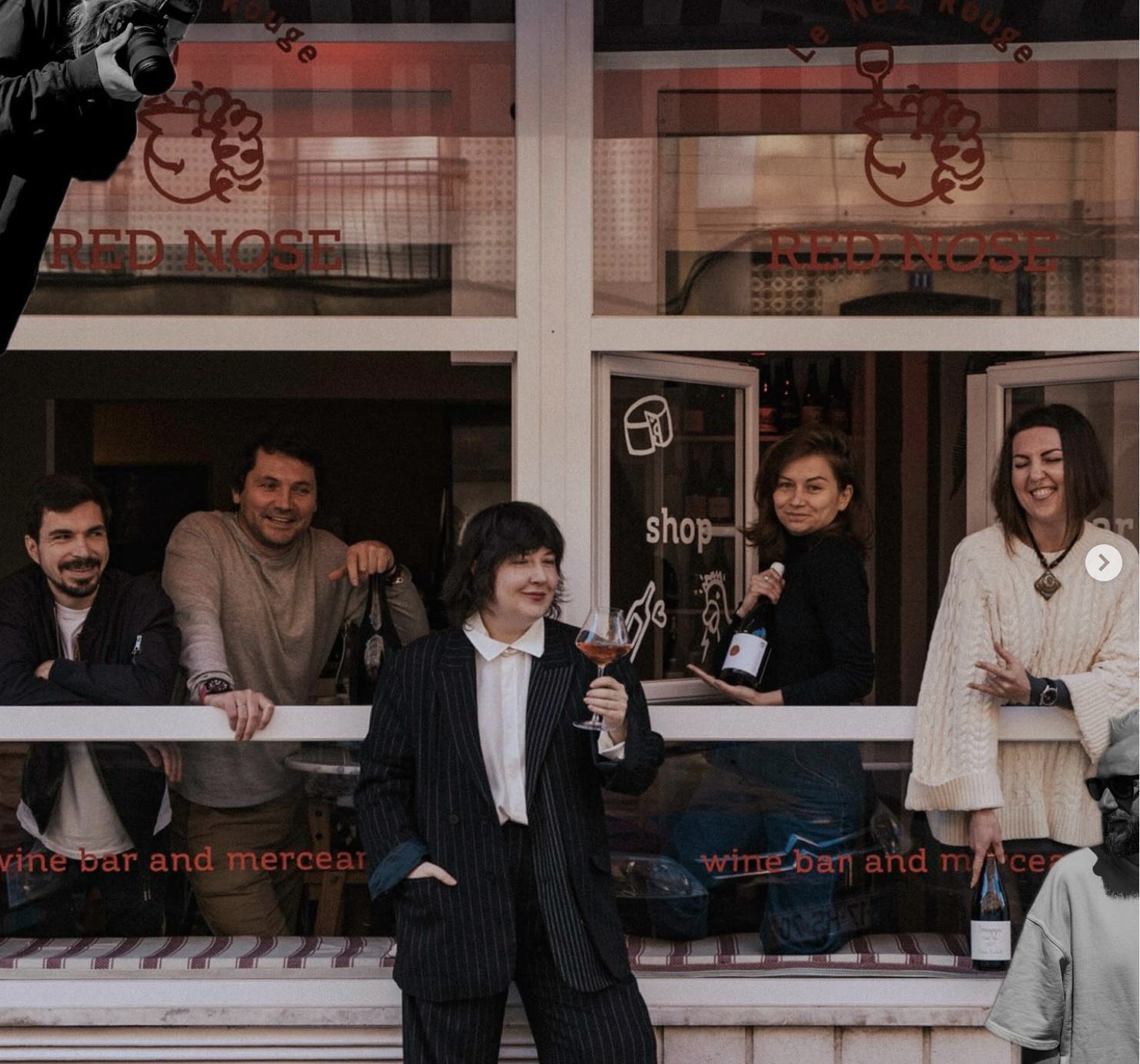 a group of people standing in front of a store