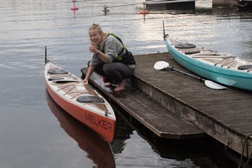 a person sitting in a boat on a body of water