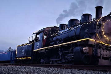 a steam engine is sitting on a train track