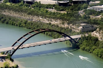 a train traveling over a bridge over a body of water