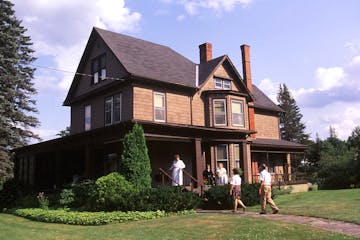a group of people in front of a house