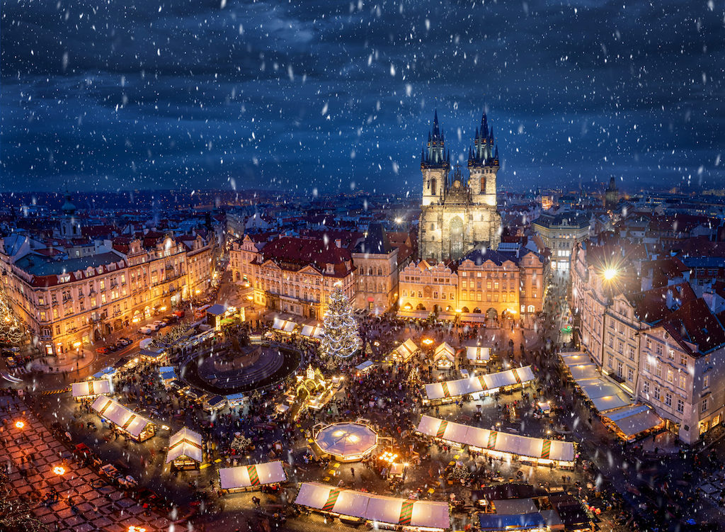 Christmas Markets in the Old Town Square of Prague seen from above during a snowy winter evening