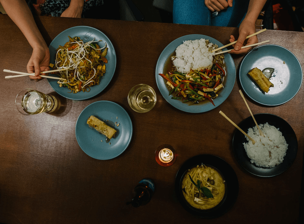 a couple enjoying delicious-looking Chinese meals in Prague
