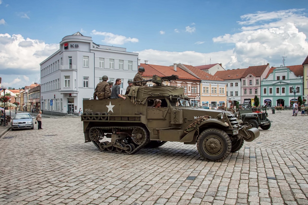 a military car inside a town square in the Czech Republic