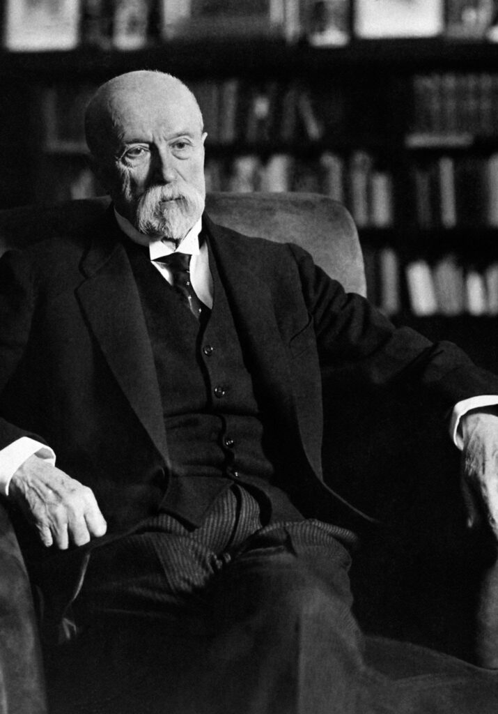 Tomas Garrigue Masaryk wearing a suit and tie sitting down
