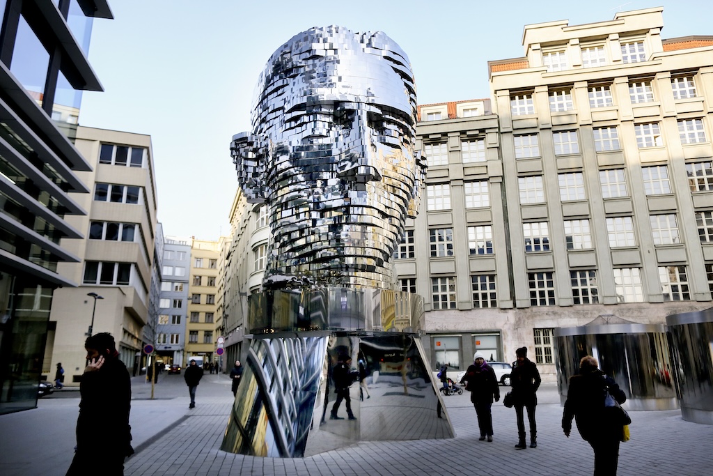 a statue of Franz Kafka in front of the Quadrio Shopping Mall in Prague's Nova Trida