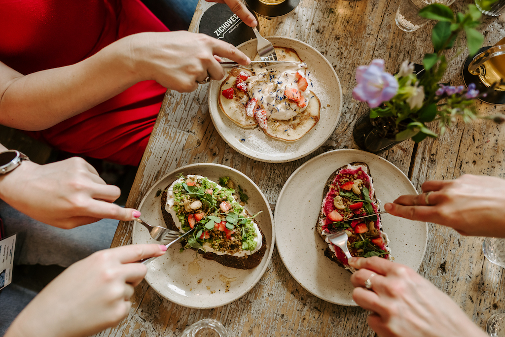people eating delicious-looking open-faced sandwiches in Prague's Letka coffee shop