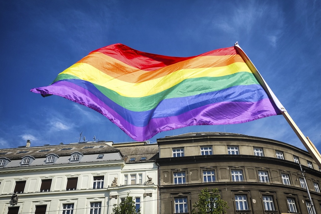the rainbow flag of the LGBTQ+ community above Prague's rooftops