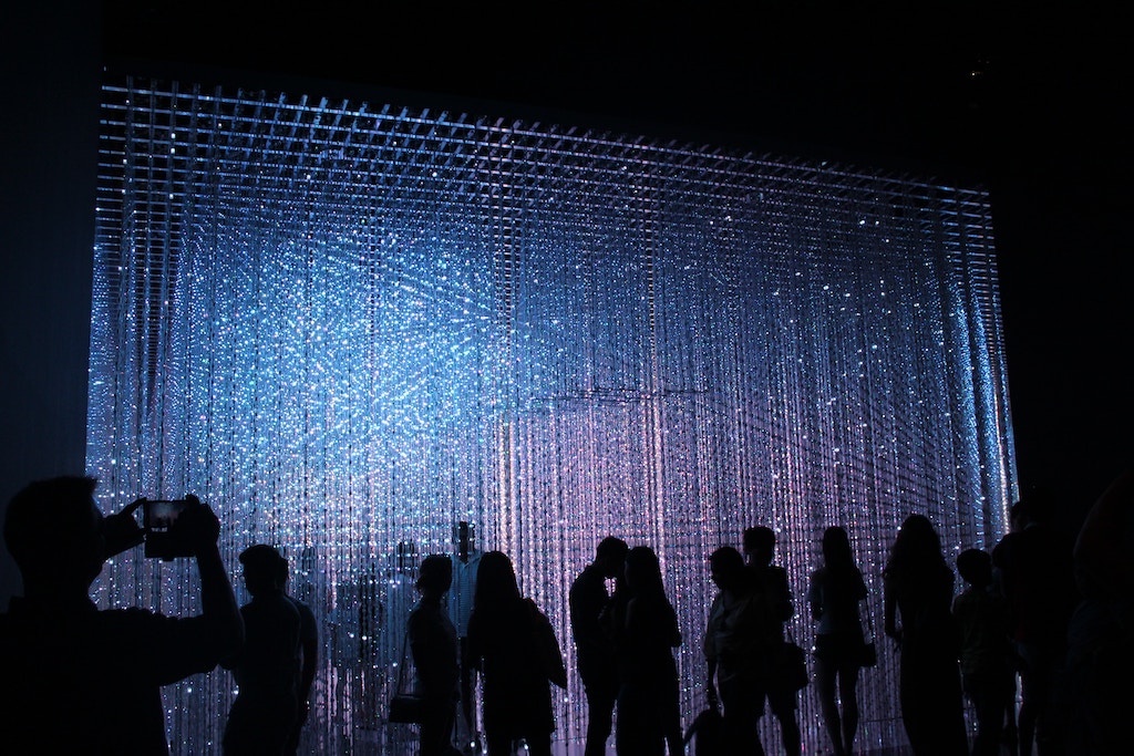 people standing in fron of a light installation during the Signal Festival in Prague