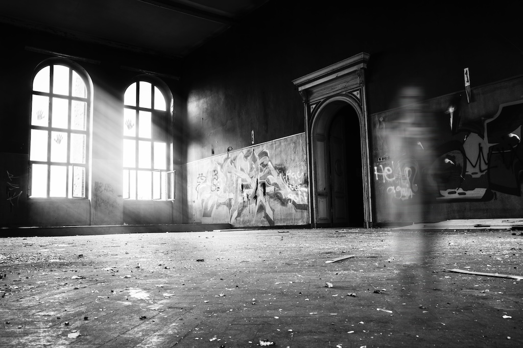 inside an abandoned building with graffiti on the walls