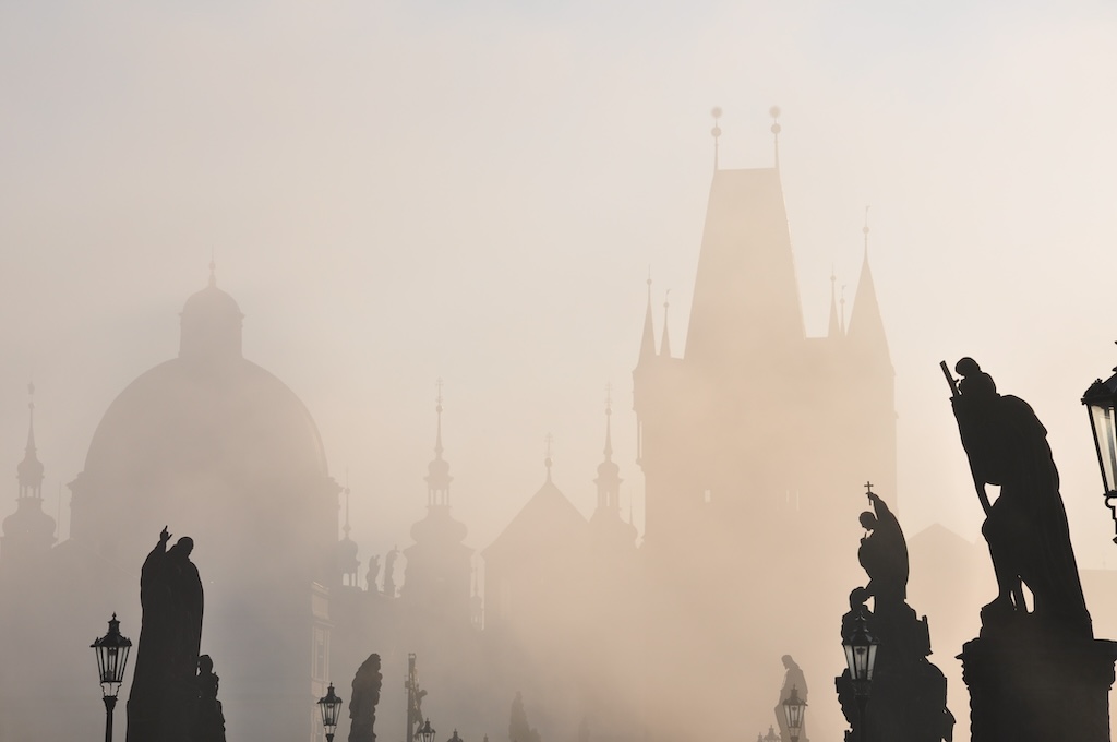 the statues on the Charles Bridge in Prague seen through a morning fog
