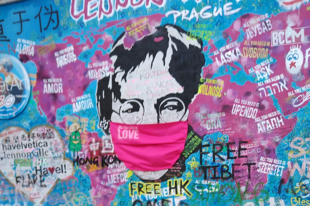 a graffiti of John Lennon wearing a face mask during Covid-19 in Prague