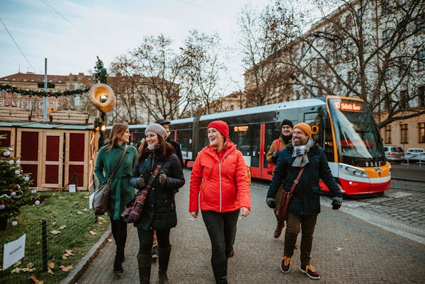 a tour guide leading a group of tourists on a winter day in Prague