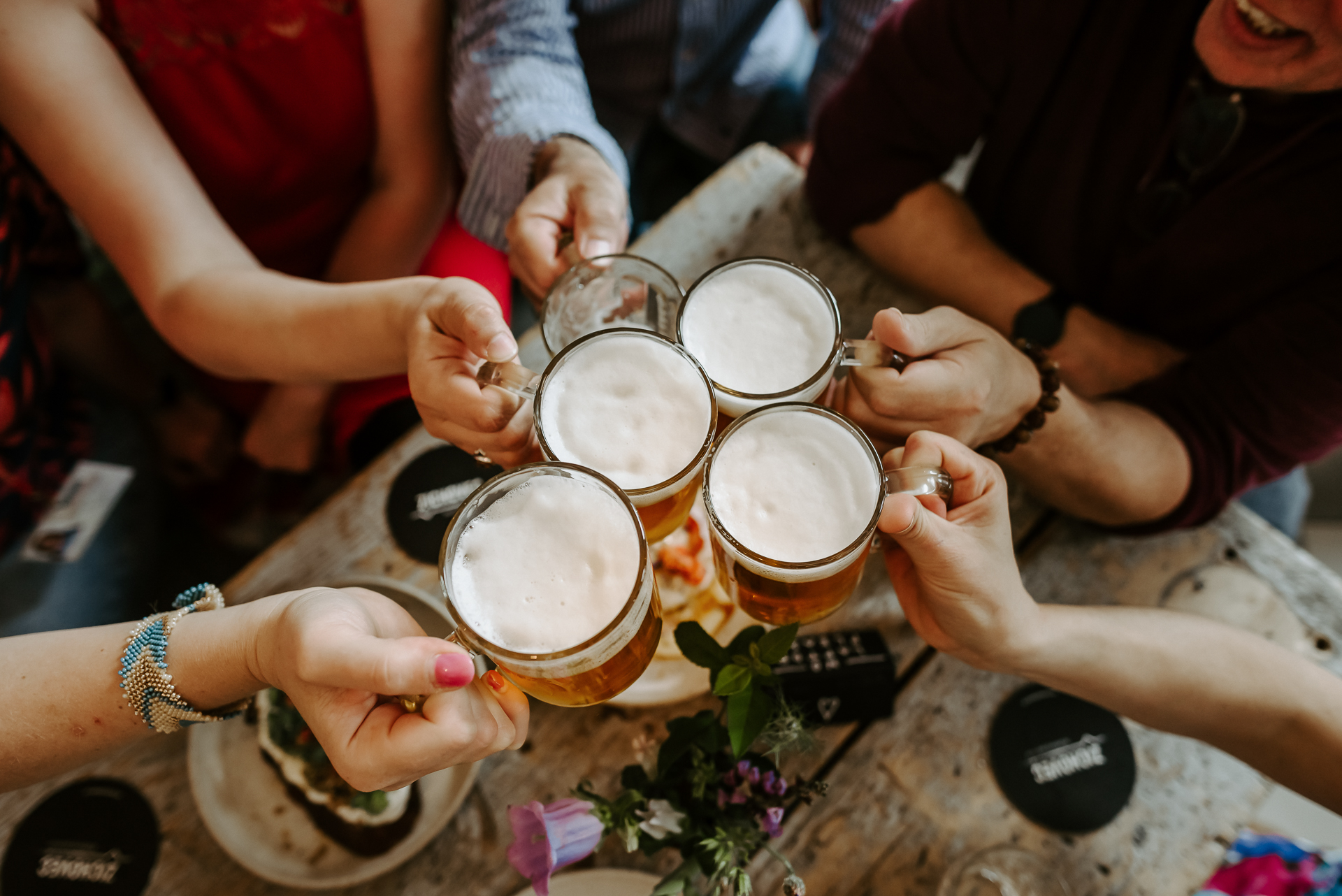 a group of people sitting at a table with food