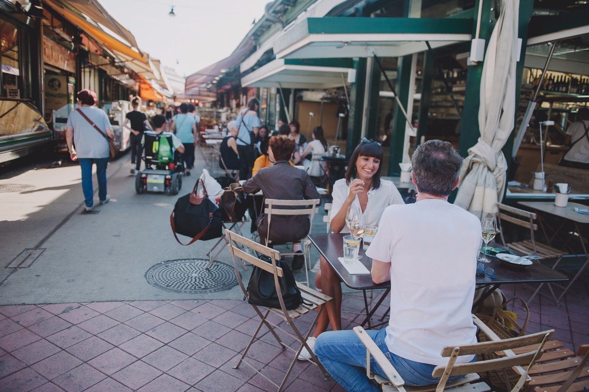 a group of people sitting at a table in front of a building