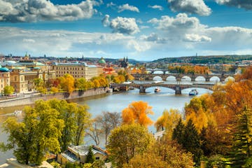 a scenic view of Prague and the Vltava River in beautiful autumn colours
