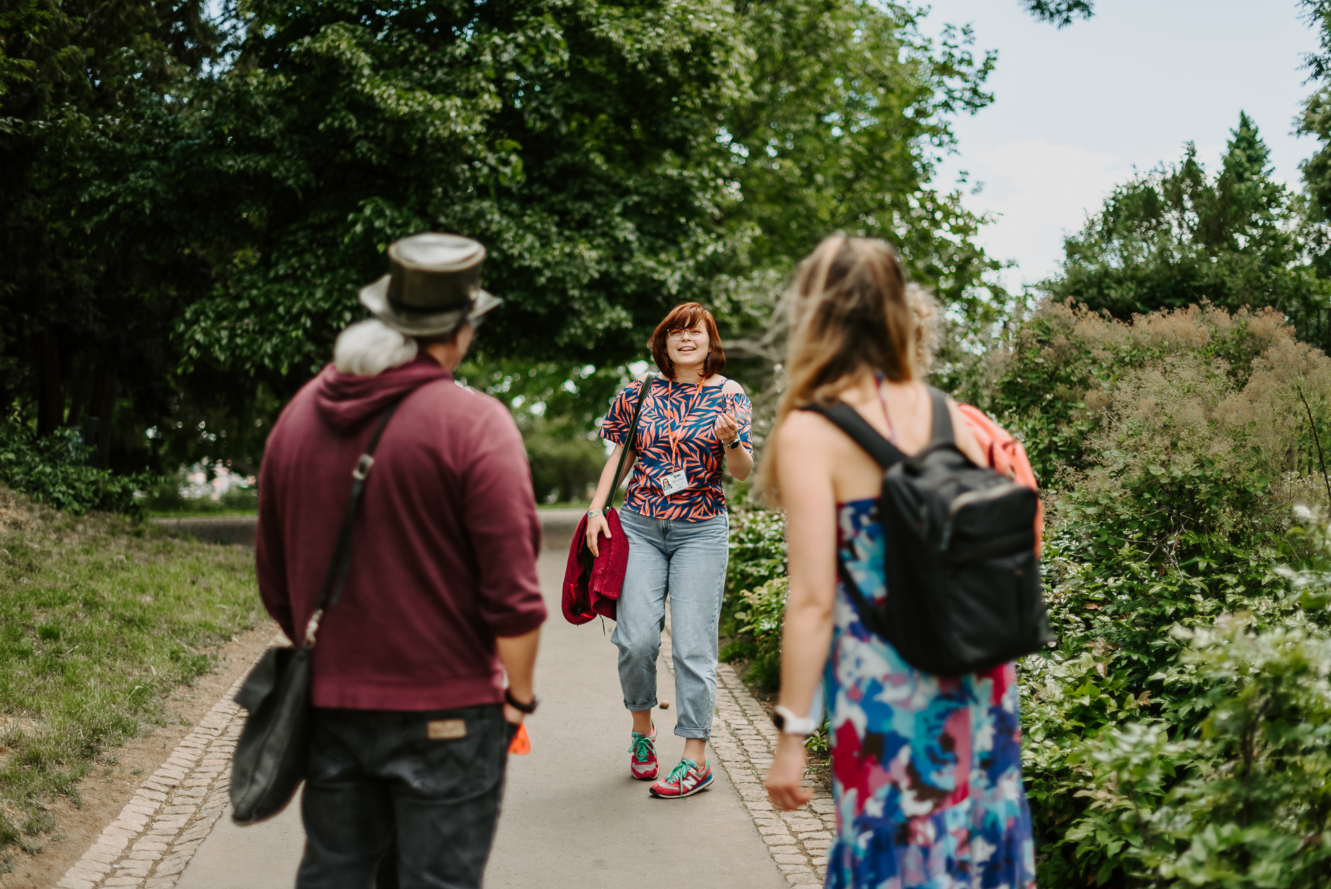 a couple of tourists following a tour guide through a park