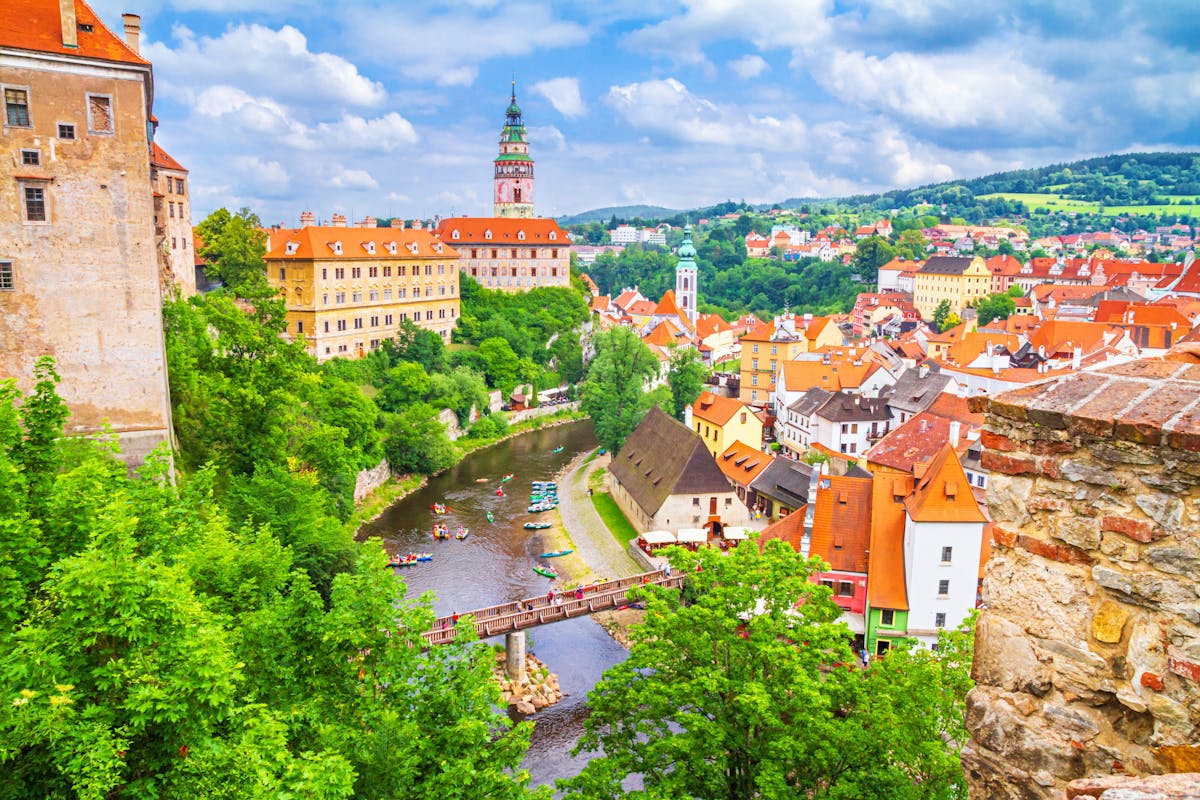 a scenic view of the historic city center of Cesky Krumlov and the Vltava River