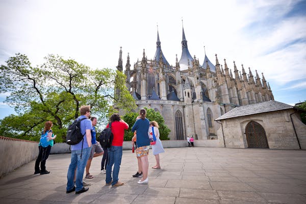a group of tourists standing in front of St Barbara's Cathedral on a Day Trip to Kutna Hora