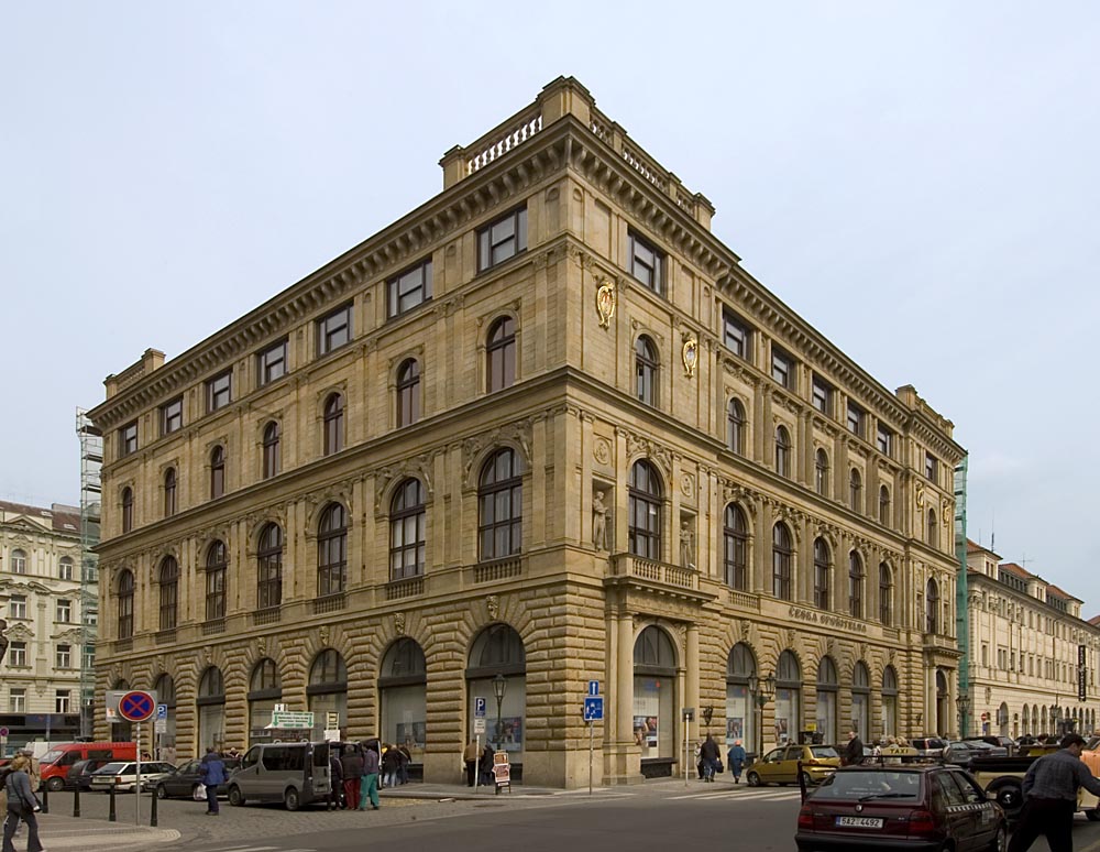 a group of people walking in front of a building