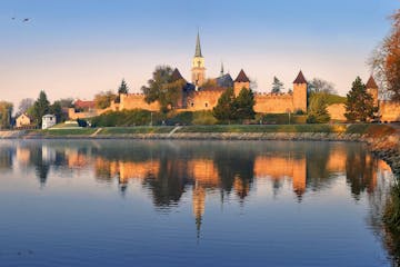 a view of the historic city center of Nymburk surrounded by brick walls from the Labe River