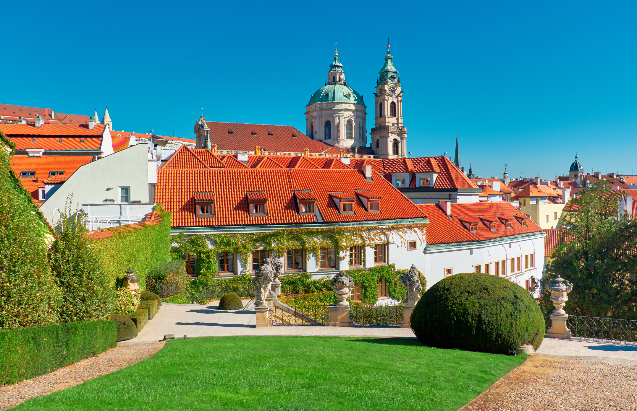 inside the Vrtba Garden in Prague with a view of St. Nicolas Church in the background