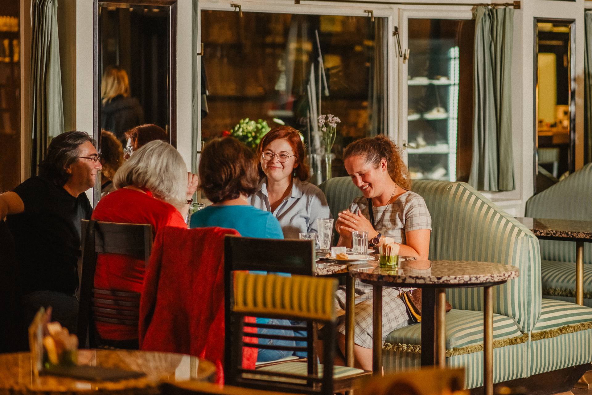 a group of people sitting at a table in a restaurant