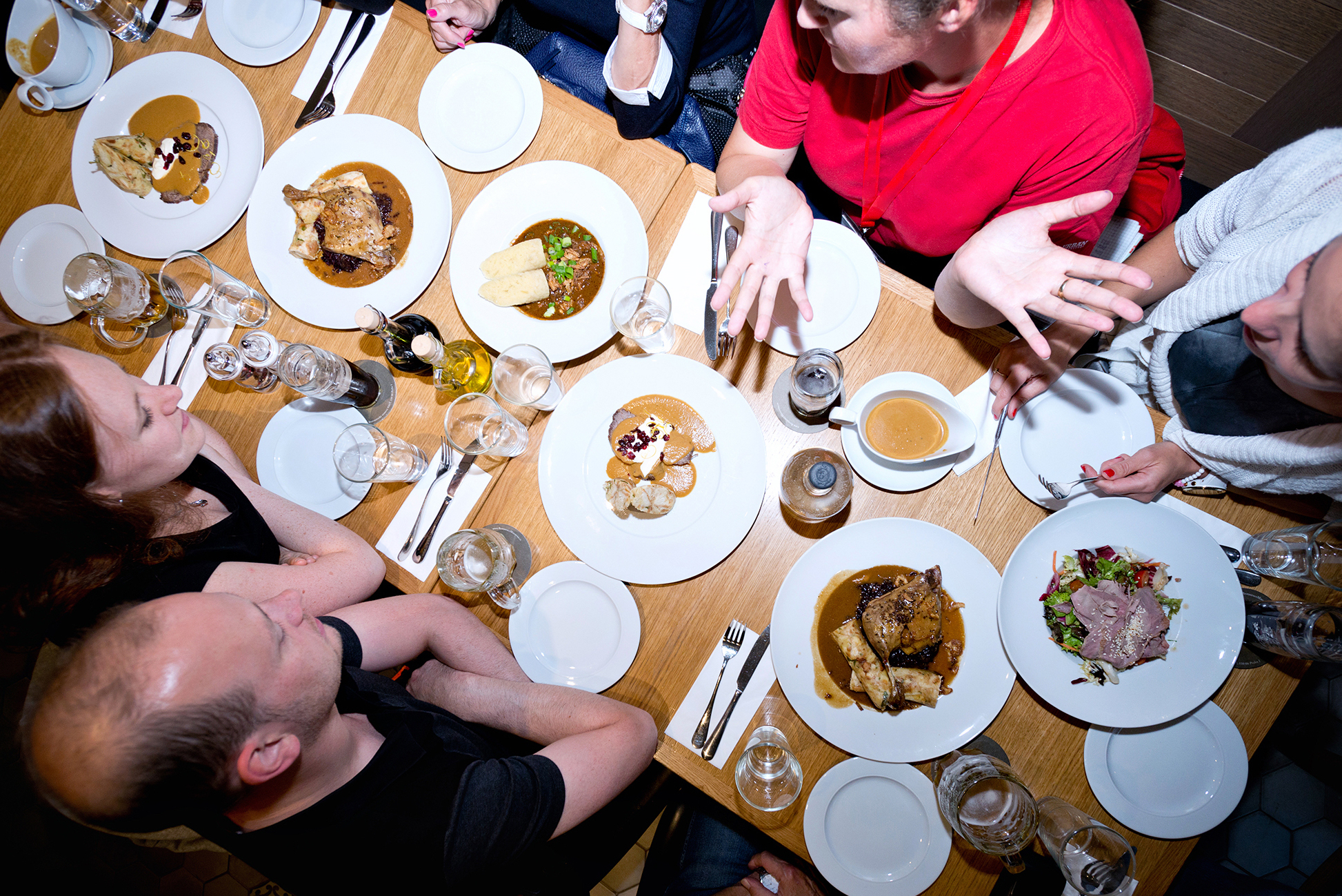 a group of people sitting at a table with a plate of food