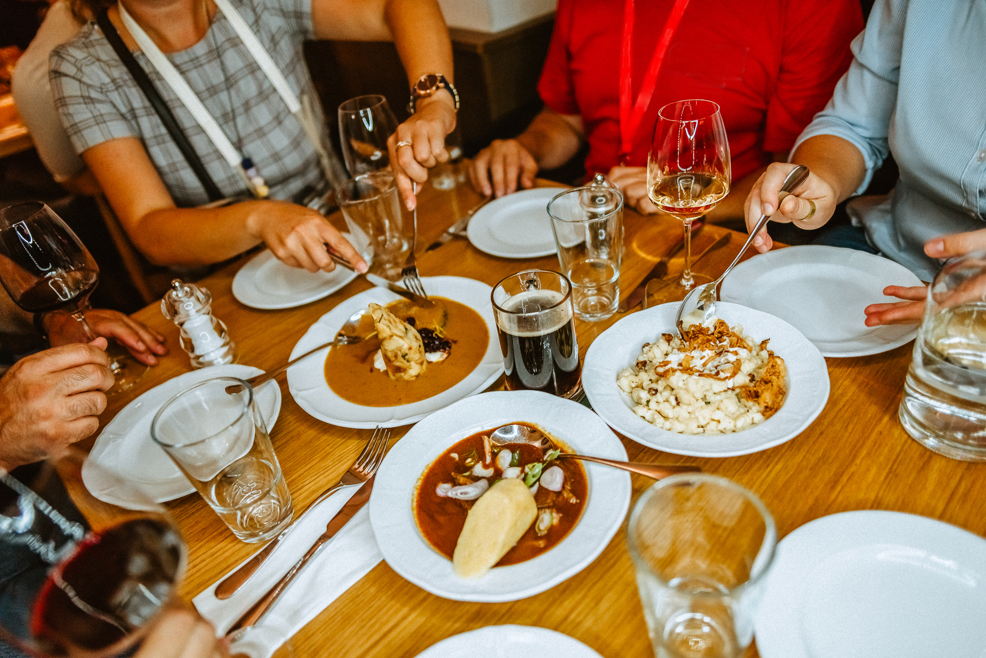 a group of people sitting at a table eating food