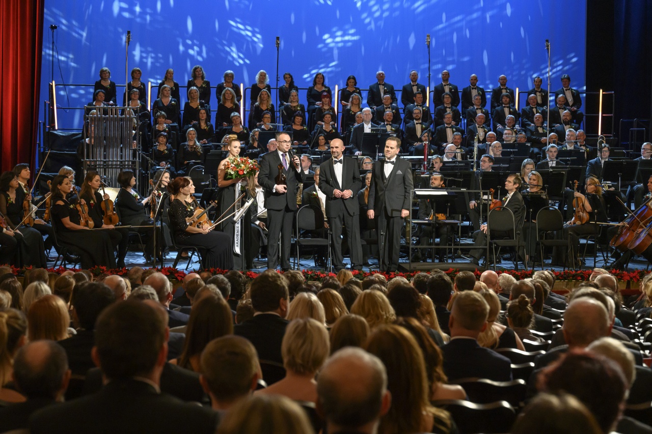 a group of people on a stage in front of a crowd