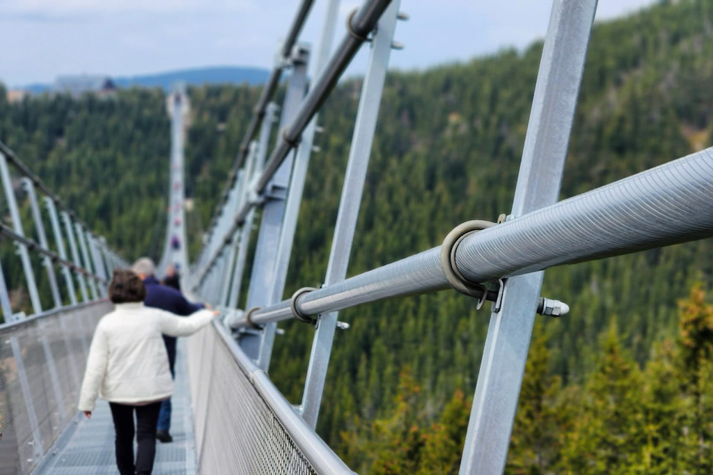 people walking on the Sky Bridge - the longest suspension bridge in the world located in eastern Czech Republic