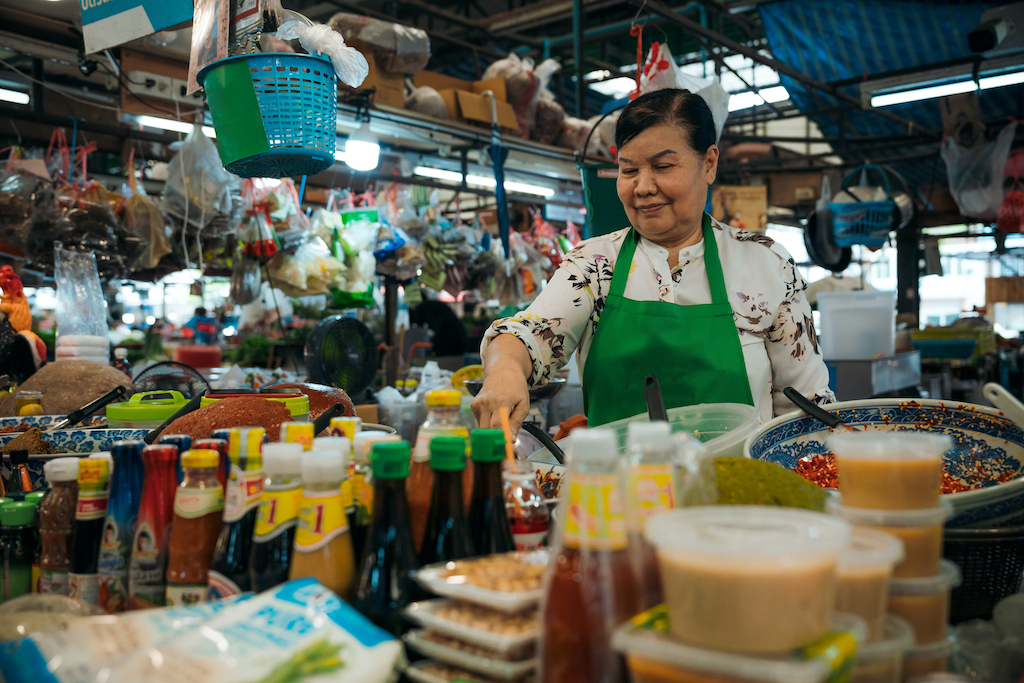 a Vietnamese lady serving food at a Vietnamese market called Sapa in Prague