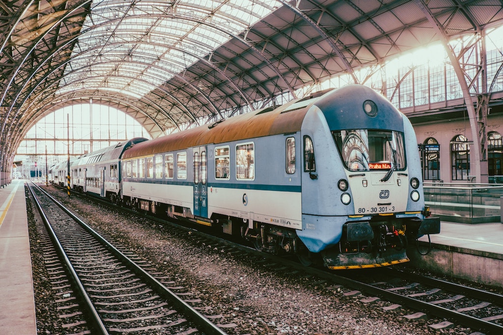 a train stationed in the historic hall of the Main Train Station in Prague
