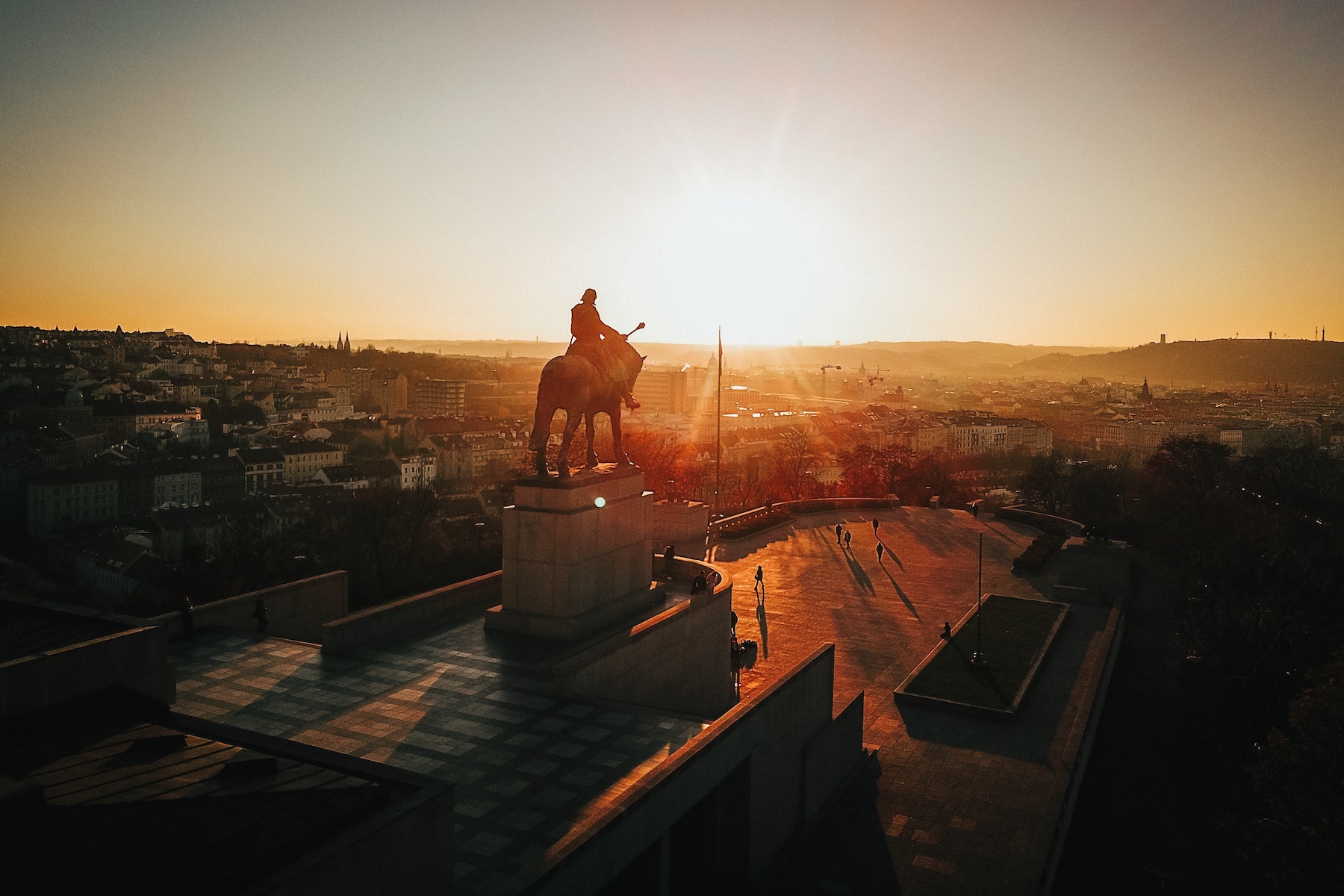 a sunset over the Vitkov Monument in Prague