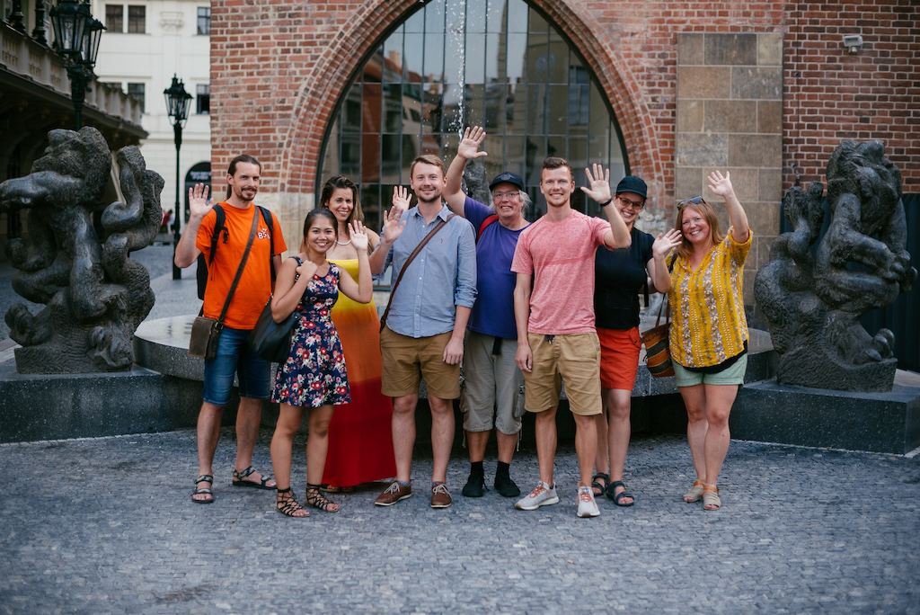 Prague City Adventures team standing together and waiving at the camera