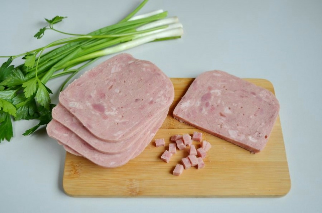 a typical Czech ham on a cutting board cut into slices