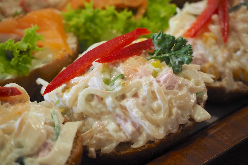 a close-up of a Czech deli-style salad on an open-faced sandwich