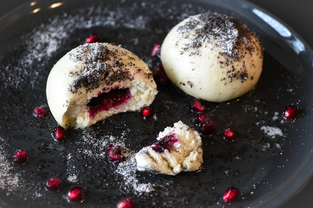 a close up of Czech blueberry-filled fruit dumplings with a poppy seed topping