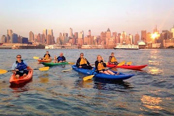 a group of people kayaking in NYC