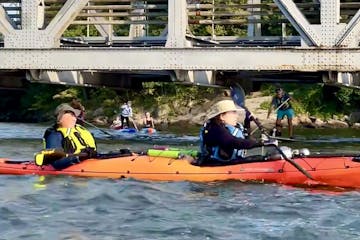 a group of people riding kayaks at Spuyten Duyvil Bridge