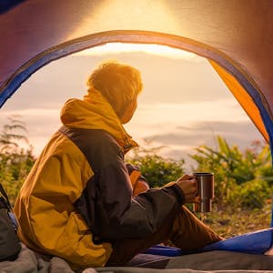 a person sitting in a tent