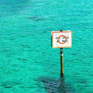 a sign above a body of water